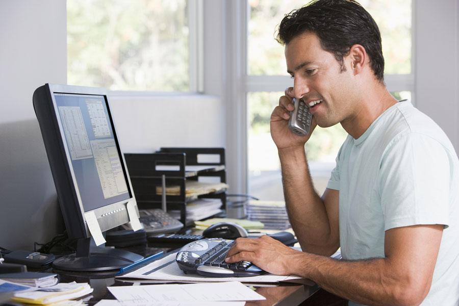 man working on computer in a home office